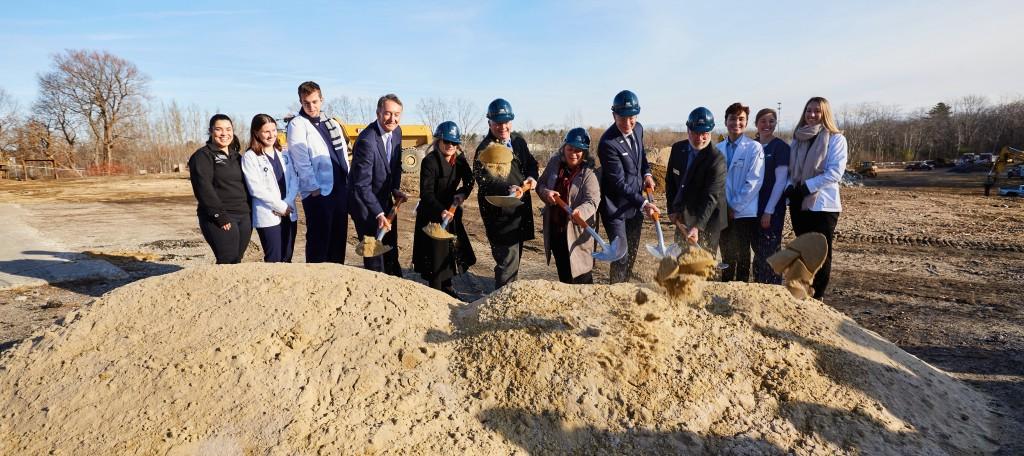 UNE leadership dig into the earth at the groundbreaking ceremony for the Harold and Bibby Center for Health Sciences on Tuesday, Nov. 29, 2022