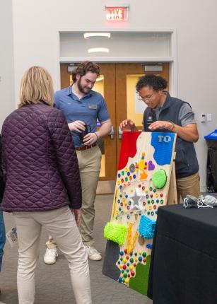 人 observe a stand-up sensory board